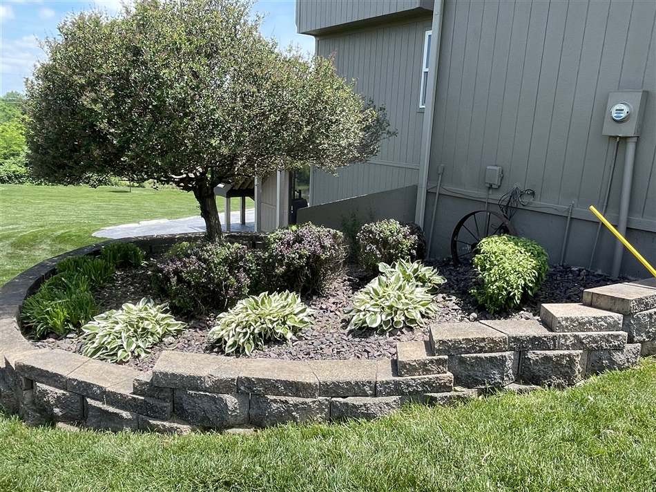 Stone retaining wall and landscaped flower bed