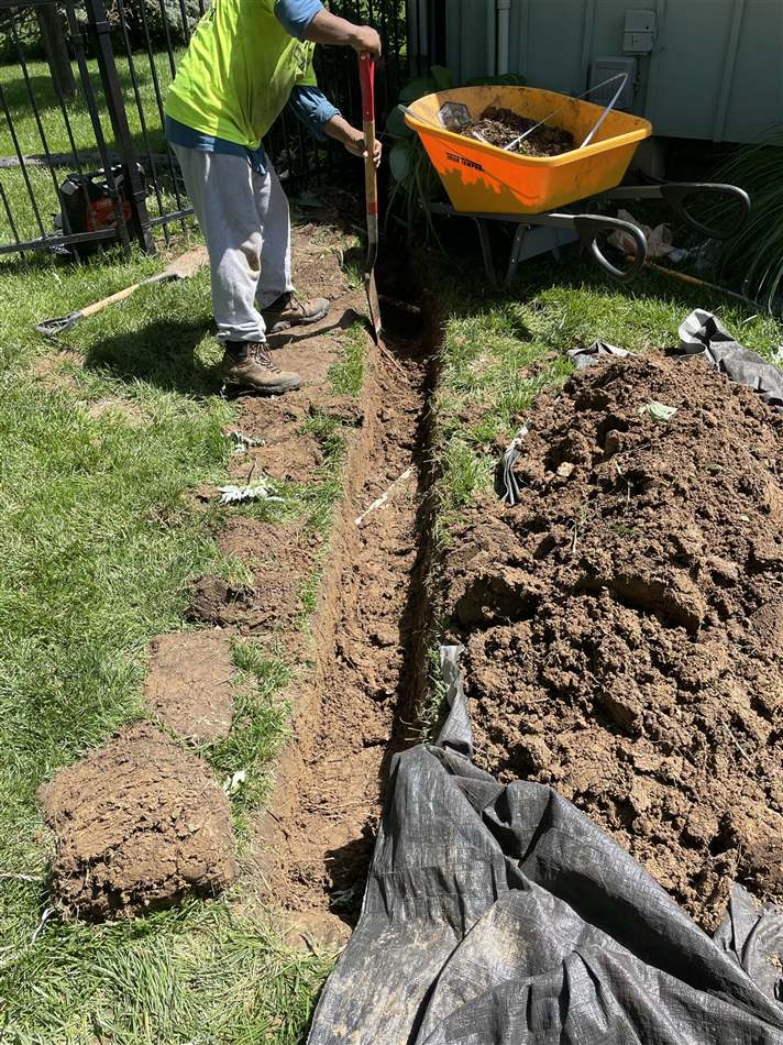 In-progress digging and prep work before landscape install